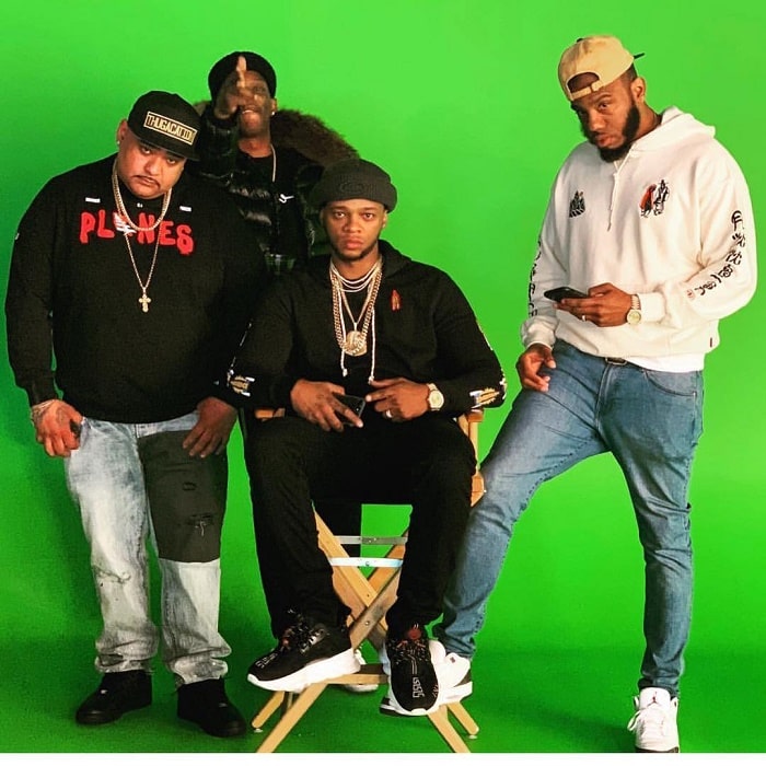 Papoose pose for a photo with his friends.